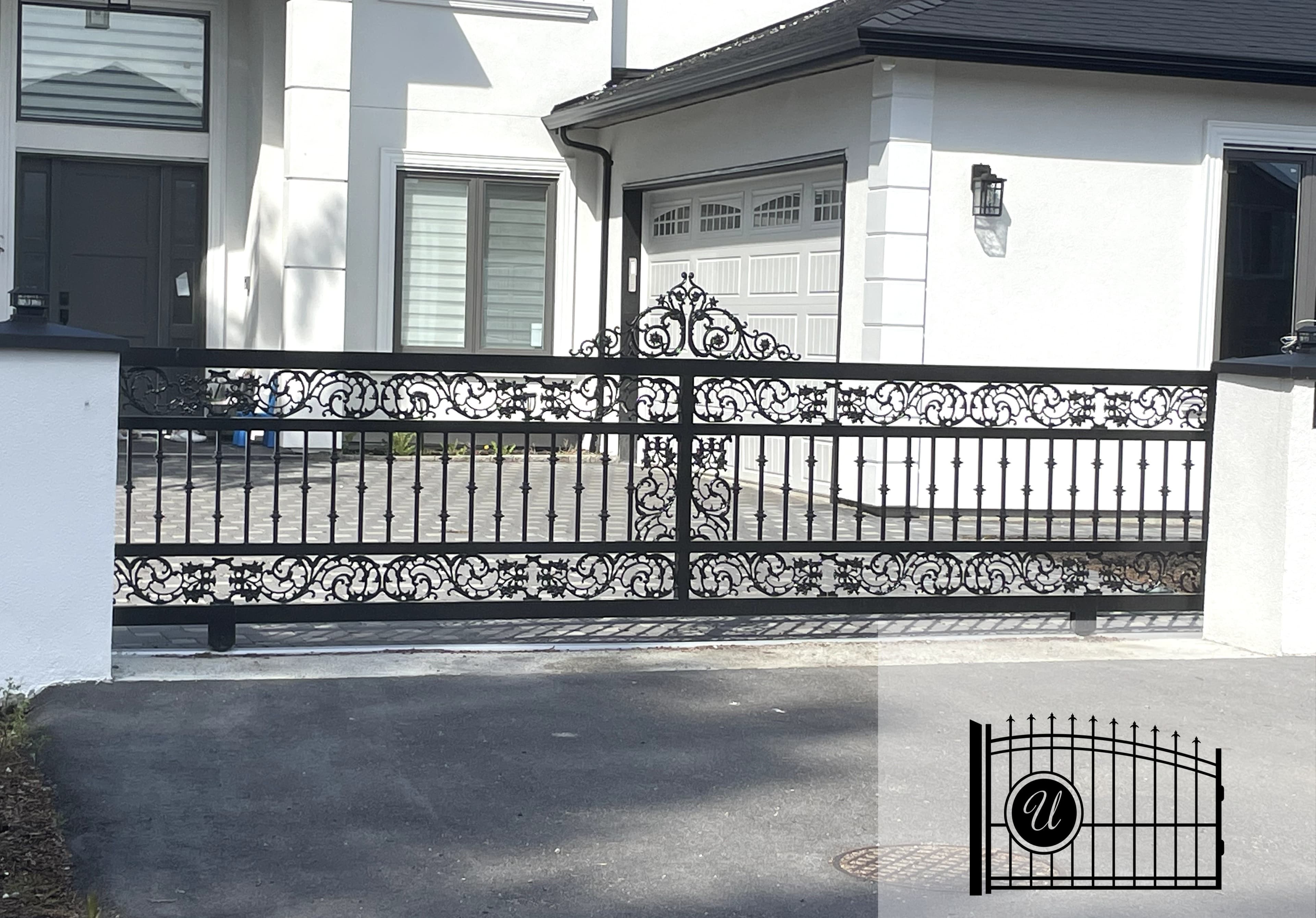 Ornamental wrought-iron driveway gate with scrollwork detailing
